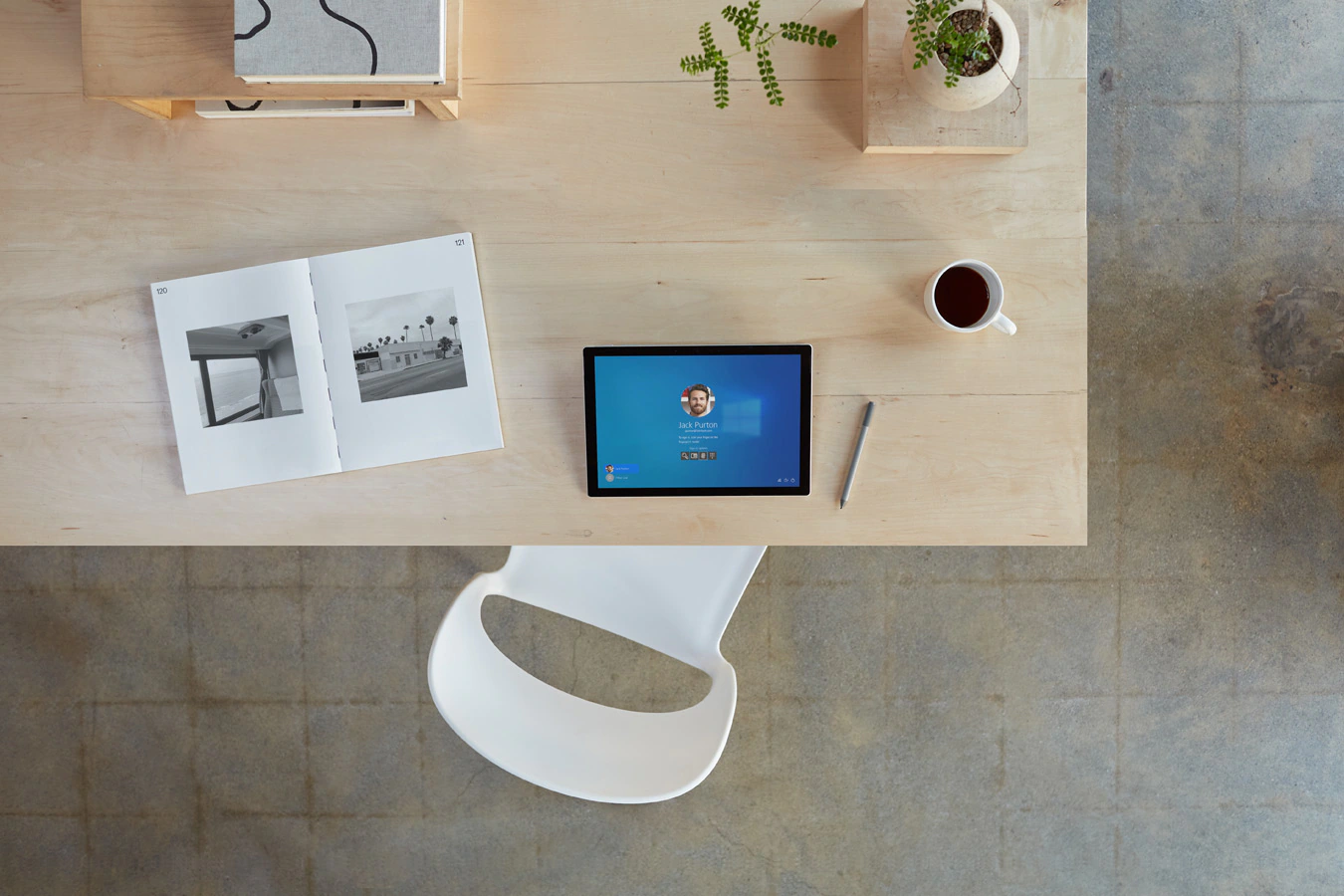 A top down view of a Surface Pro 7+ device on a home office desk surrounded by accessories