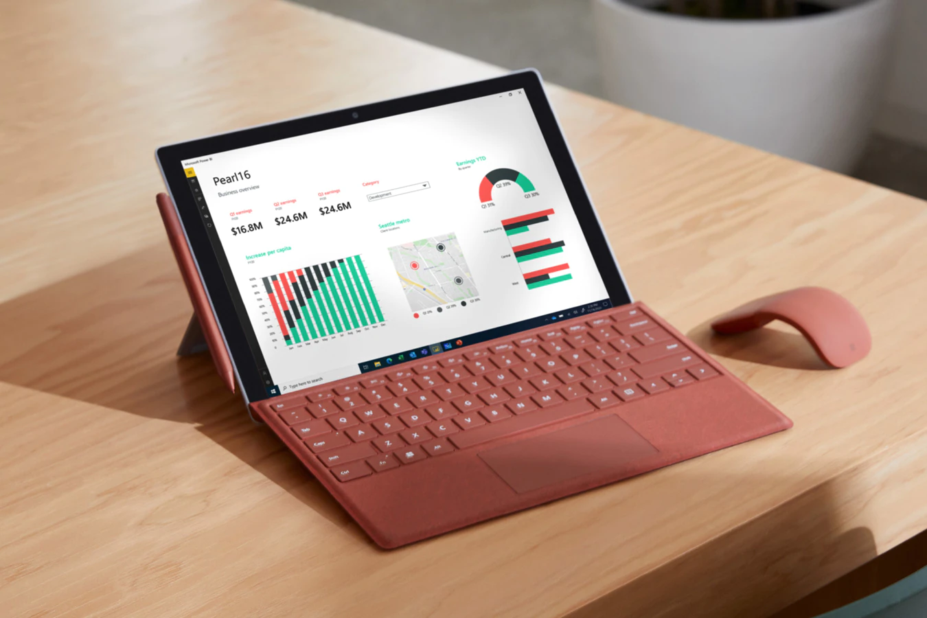 Surface Pro 7+ is pictured on a home office desk with Surface Pro X Signature Type Cover attached, Surface Pen, and Surface Arc Mouse all in Poppy Red color.